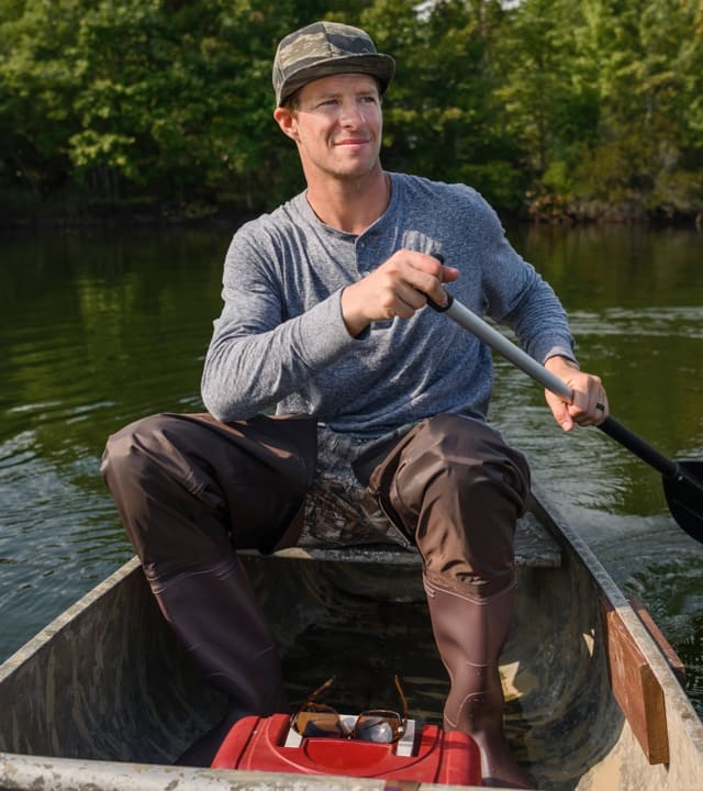 Zach paddling on a boat.