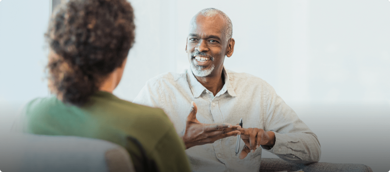 A man looking at a woman and speaking to her.