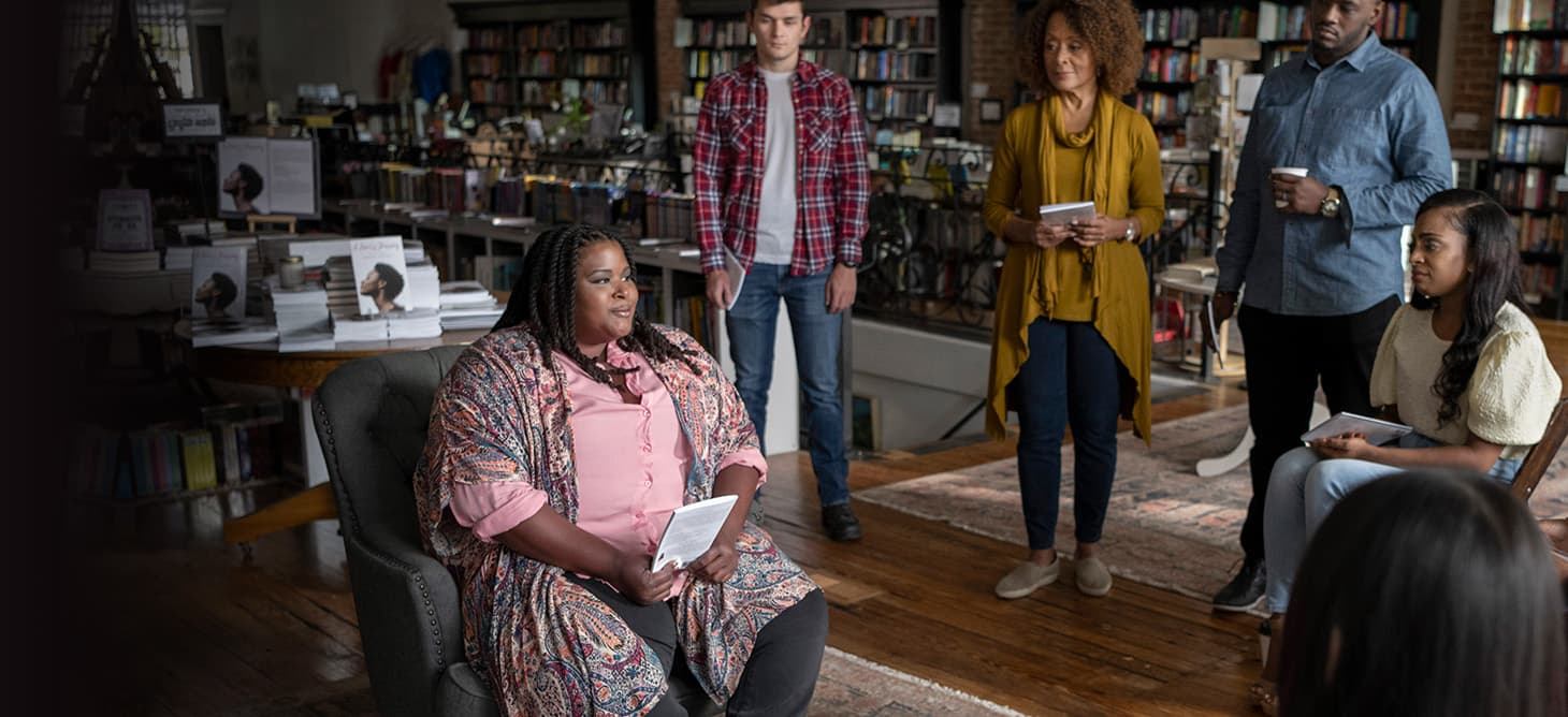 Nikki is sitting down with others.