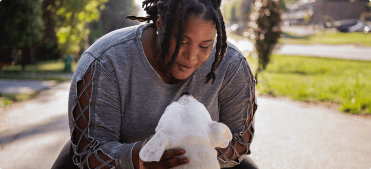 Nikki is petting a dog.