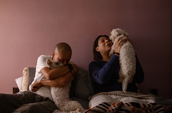 D’Eva holding her pet dog.