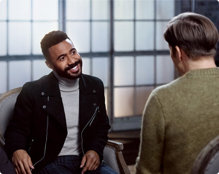 Dimitri is smiling in conversation with Chad.