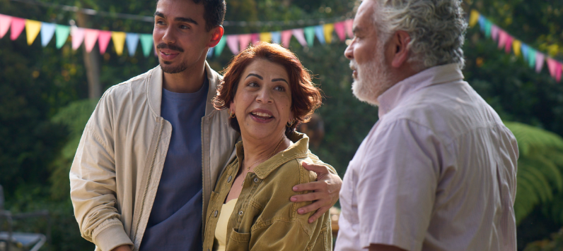 Maricela and her family are standing outside at a celebration.