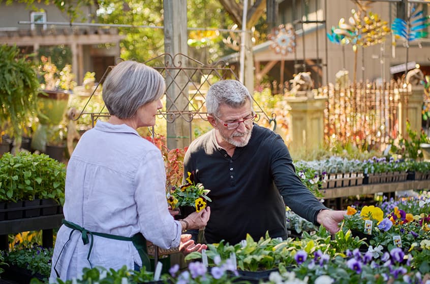 Theron is picking flowers with a woman.