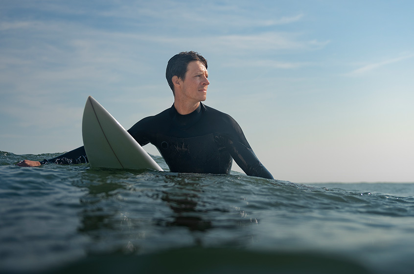 Zach is surfing.