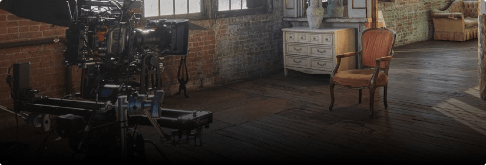 Camera equipment and a chair in a room.