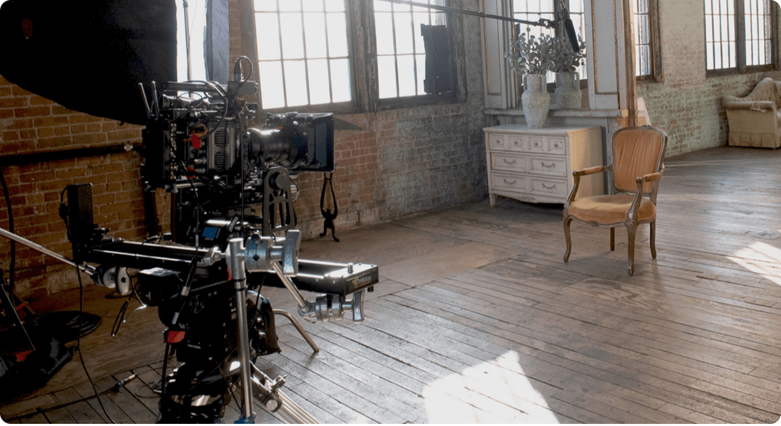 Camera equipment and a chair in a room.