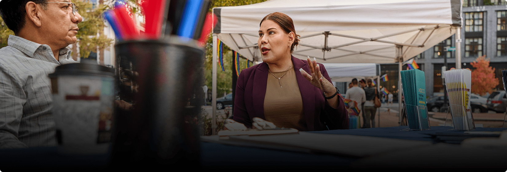 D’Eva explaining something while a man listens to her.