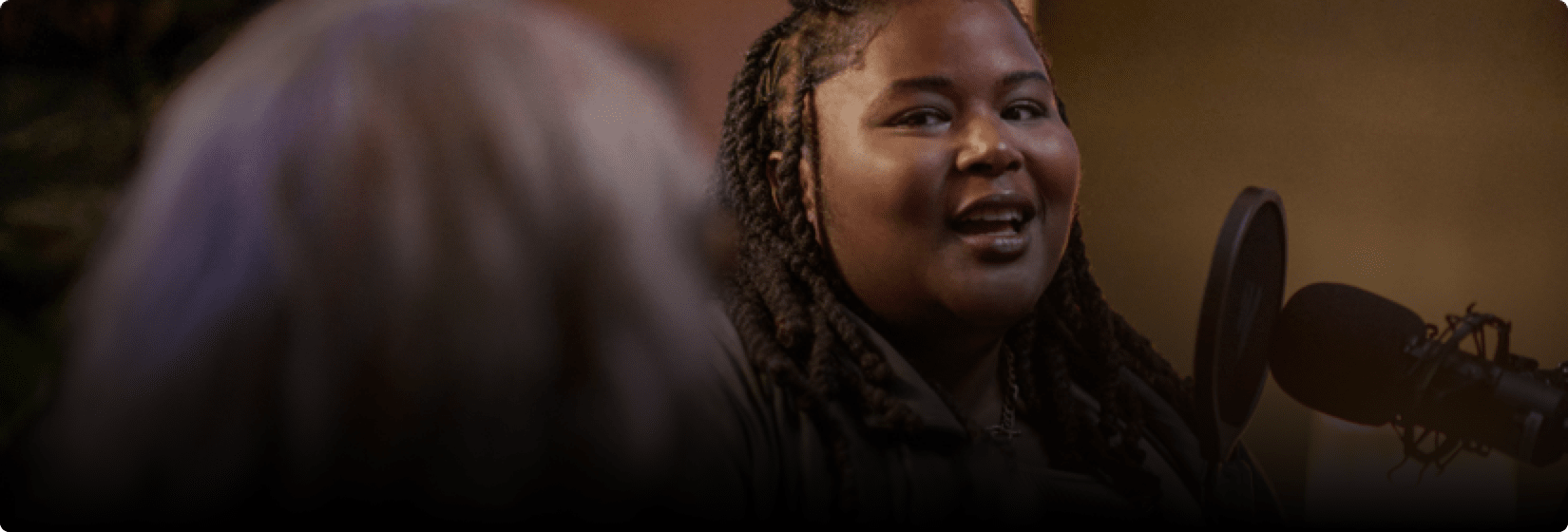 Nikki singing into a microphone.