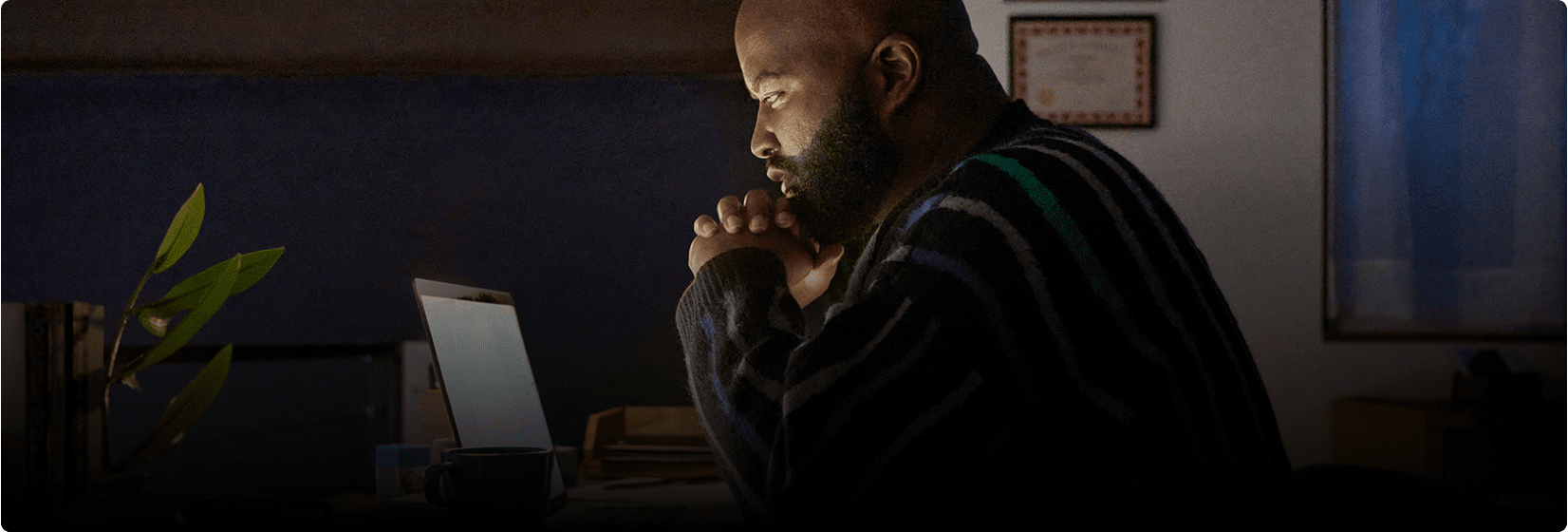 Phil thinking while staring at his laptop.