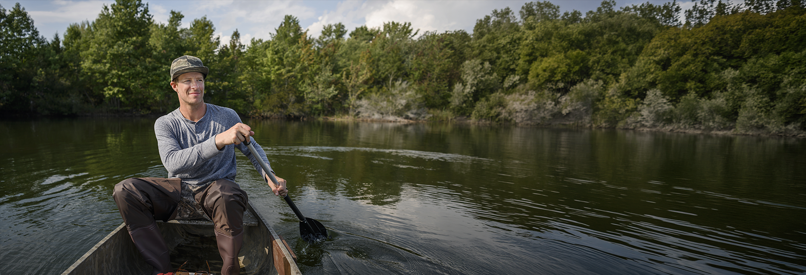 Zach is outside boating.